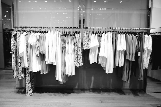 A brightly lit, modern clothing boutique featuring racks of neatly organized women's clothing made from organic materials. Tags highlight the sustainable practices used in the production of each garment.