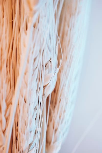A detailed close-up of organic cotton fabric being inspected in a textile factory. The focus is on the texture and weave of the fabric, emphasizing its natural and sustainable qualities.