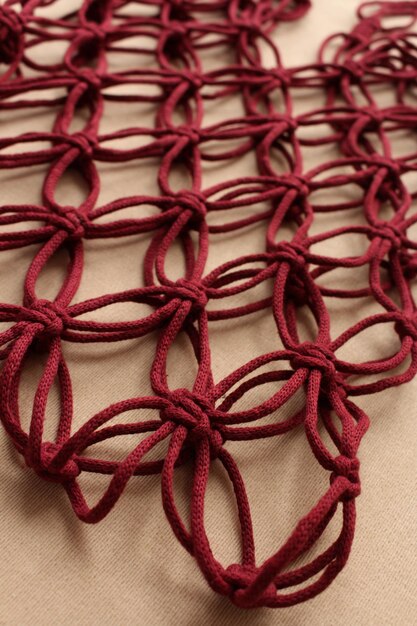 A close-up shot of a silk scarf tied in a Parisian knot, showcasing the intricate pattern and delicate texture of the fabric.