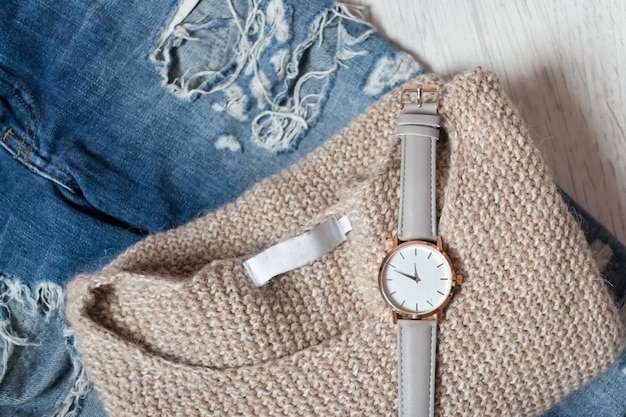 A close-up shot featuring a variety of affordable accessories, including a colorful scarf, a simple watch, and understated jewelry. The shot emphasizes how these items can enhance a basic outfit.