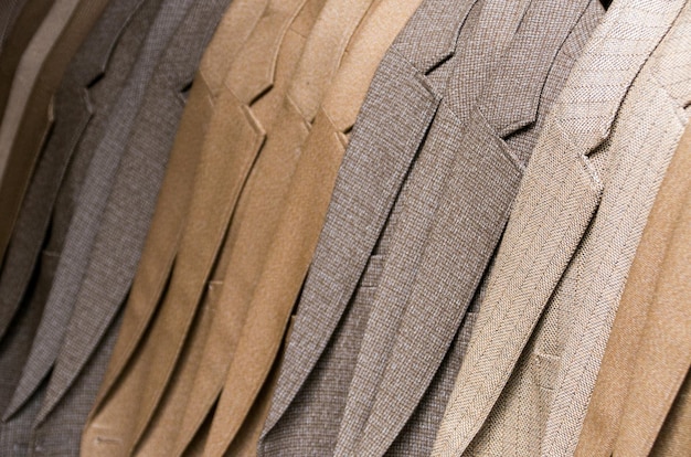 A display of cotton suits in various shades, showing the fabric's versatility and casual appeal, with examples of different weaves like twill and seersucker.