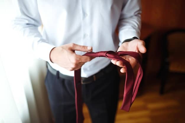 A close-up image of a man's hands carefully tying a Half Windsor knot, with a clear view of the tie's fabric and the steps involved.