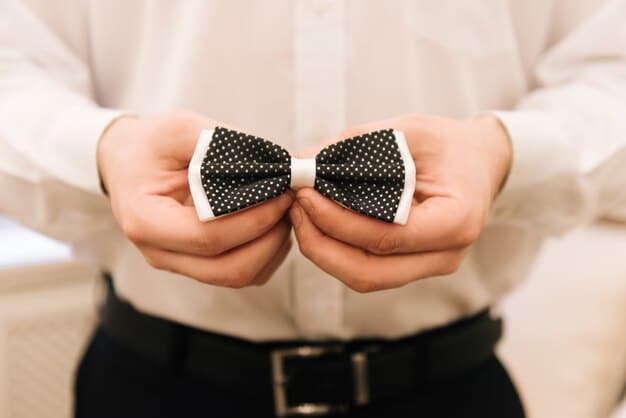 A man's hands expertly shaping a Bow Tie, showcasing its elegant and classic form, with a blurred background of a formal event.