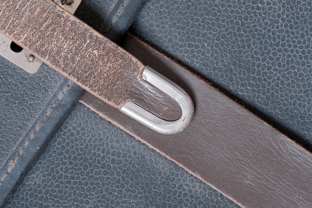 A close-up shot of different belt materials (leather, canvas, suede) laid side by side. The textures and grains of each material are clearly visible, with labels identifying each type.