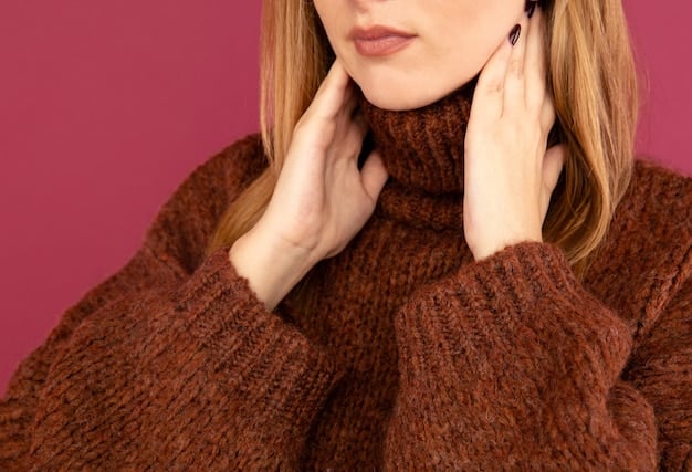 A close-up shot of a creamy white turtleneck sweater paired with a camel-colored wool coat. The texture of the knit and the smooth finish of the wool are highlighted, emphasizing the luxurious feel of the outfit.
