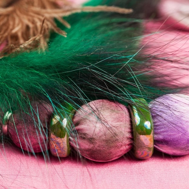 A close-up of various fabric swatches in a range of bold colors like emerald green, fuchsia pink, and vibrant orange, arranged to display complementary combinations for different skin tones.