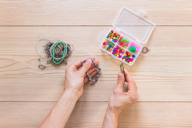 A close-up shot of a person's hands adding colorful beads to a homemade bracelet. The bracelet is on a table filled with various beads, strings, and crafting tools, showcasing the process of DIY accessorizing for festival fashion.