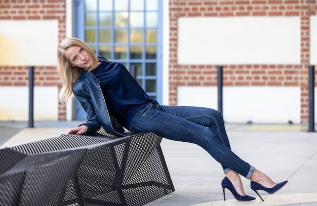 A woman wearing dark-wash jeans, a silk blouse, and heels, showcasing a perfect example of casual chic date night dressing. She is smiling and holding a coffee cup, set against a blurred backdrop of a trendy coffee shop.