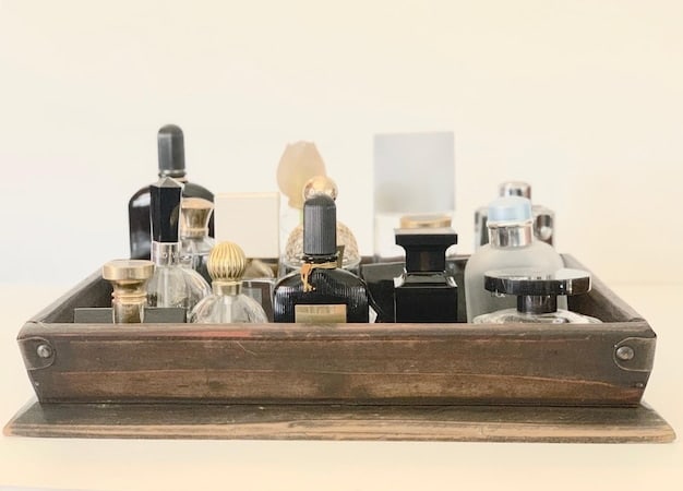 A slightly zoomed-out shot showing a collection of perfume bottles on a dressing table, with one bottle showing a noticeable darkening of the liquid compared to the others.