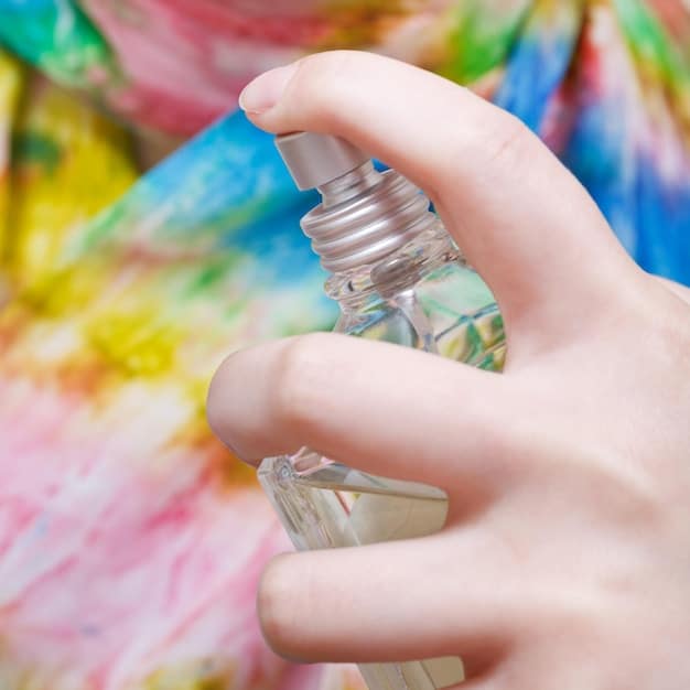 A close-up shot of a person's wrist, showcasing different fragrances being sprayed from various perfume bottles. The positioning should illustrate layering, and the focus should be on the aromatic mist and the skin's reaction to the fragrances.