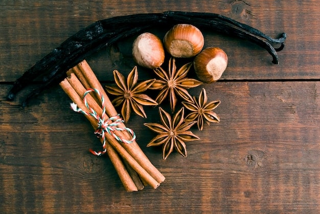 A collection of raw ingredients commonly used in oriental fragrances, such as vanilla beans, cinnamon sticks, amber resin, and spices, arranged to highlight the rich and exotic nature of the scent family.