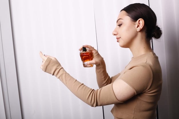 A woman applying perfume to her wrist, demonstrating a classic fragrance application point, with a focus on the elegant movement and the perfume bottle in her hand.