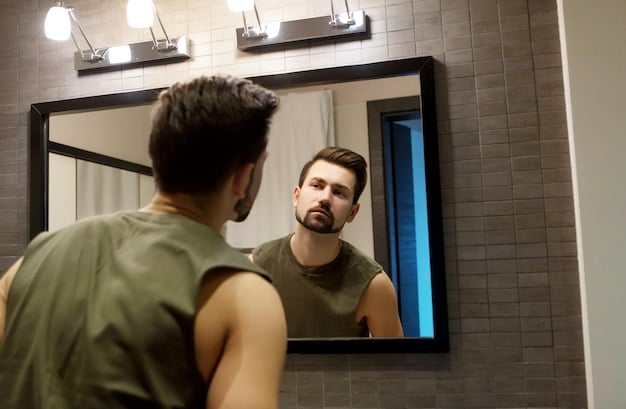 A Canadian man is shown in front of a mirror styling his short, textured hair with a matte clay product. He is focused and precise, and his reflection shows a confident expression.