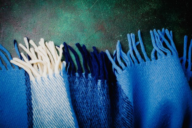 A close-up shot of recycled denim jeans that have been creatively patched together to form a stylish jacket. The patches are of various colours and textures, showcasing the upcycled nature of the garment. The photo highlights the intricate stitching and unique design elements.