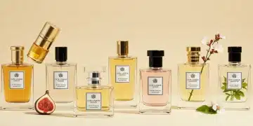 Luxurious perfume bottles representing trending fragrance notes for 2025, including amber, fig, cardamom, cherry blossom, and vetiver.