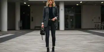 Woman wearing tailored blazer, dark wash jeans, and leather boots for 2026 wardrobe